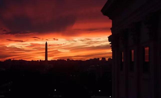 The sunset is seen from the Capitol before Republican and Democratic news conferences about the government shutdown, Tuesday, Sept. 30, 2025, on Capitol Hill, in Washington. (AP Photo/Jacquelyn Martin)