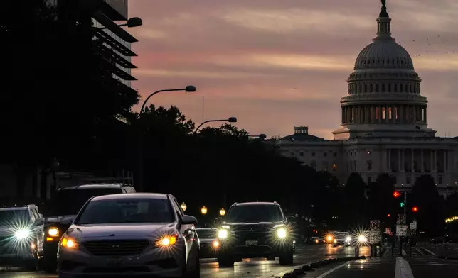 The U.S. Capitol is seen at sunrise as cars drive on Pennsylvania Ave. during rush hour traffic, Wednesday, Oct. 1, 2025, in Washington. (AP Photo/Julia Demaree Nikhinson)