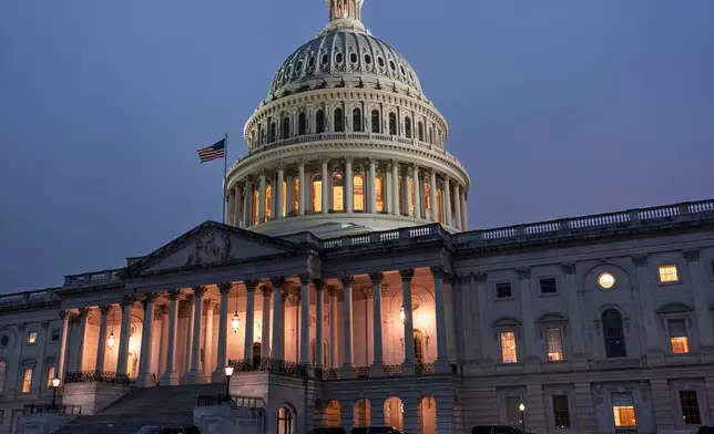 The Capitol is seen at dusk as Democrats and Republicans in Congress are angrily blaming each other and refusing to budge from their positions on funding the government, in Washington, Tuesday, Sept. 30, 2025. (AP Photo/J. Scott Applewhite)