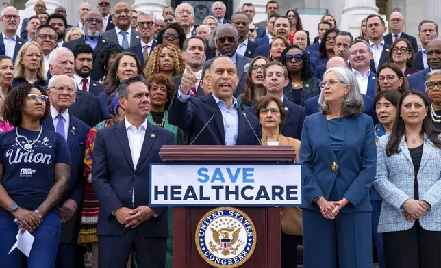 House Minority Leader Hakeem Jeffries, D-N.Y., center, flanked by Rep. Pete Aguilar, D-Calif., left, and Rep. Katherine Clark, D-Mass., arrives to speak on the steps of the Capitol to insist that Republicans include an extension of expiring health care benefits as part of a government funding compromise, in Washington, Tuesday, Sept. 30, 2025. (AP Photo/J. Scott Applewhite)
