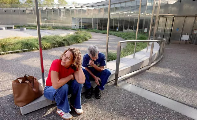Christy Lock and Curt Rohrman, from Houston get a phone call informing them their tickets for a tram ride to the top of Gateway Arch are cancelled due to the federal government shutdown and that they will be receiving a refund on Wednesday, Oct. 1, 2025 in St. Louis. (David Carson/St. Louis Post-Dispatch via AP)