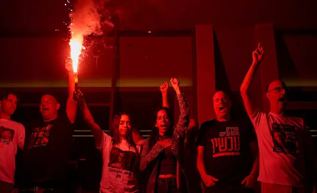 Einav Zangauker, center, mother of Matan Zangauker, who is being held hostage by Hamas, celebrates along with other families and supporters of Israeli hostages after the announcement that Israel and Hamas have agreed to the first phase of a peace plan, as they gather at a plaza known as the hostages square in Tel Aviv, Israel, Thursday, Oct. 9, 2025. (AP Photo/Ohad Zwigenberg)