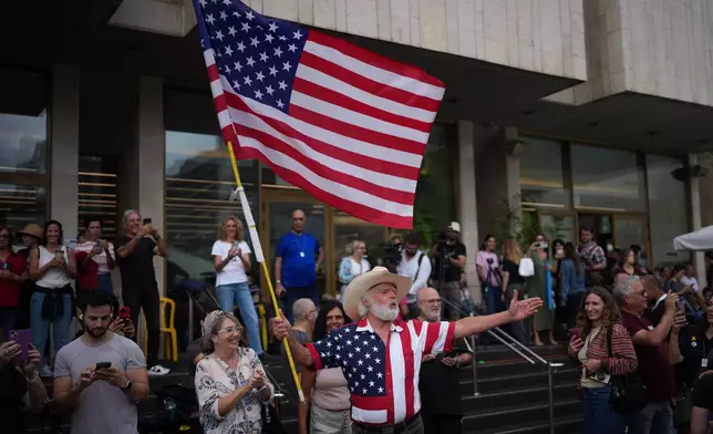 People celebrate following the announcement that Israel and Hamas have agreed to the first phase of a peace plan to pause the fighting, at a plaza known as hostages square in Tel Aviv, Israel, Thursday, Oct. 9, 2025. (AP Photo/Emilio Morenatti)