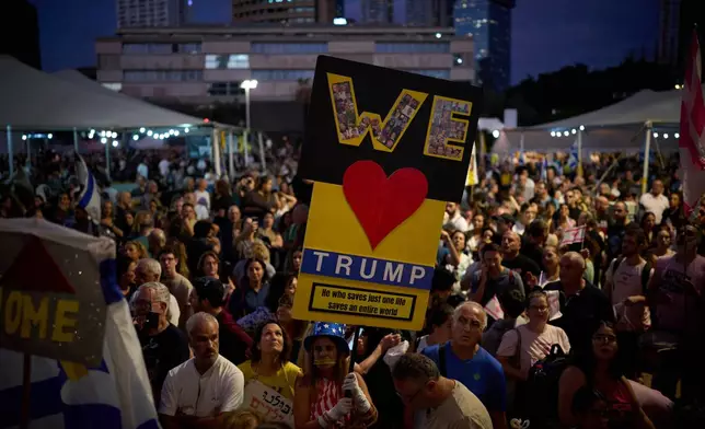 People gather to celebrate following the announcement that Israel and Hamas have agreed to the first phase of a peace plan to pause the fighting, at a plaza known as Hostages Square in Tel Aviv, Israel, Thursday, Oct. 9, 2025. (AP Photo/Emilio Morenatti)