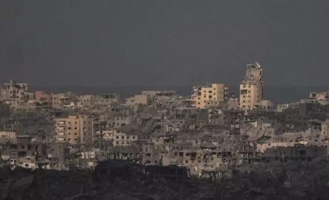 Buildings that were destroyed during the Israeli ground and air operations stand in the northern Gaza Strip, as seen from southern Israel, Thursday, Oct. 9, 2025, following the announcement that Israel and Hamas have agreed to the first phase of a peace plan to pause the fighting. (AP Photo/Ariel Schalit)