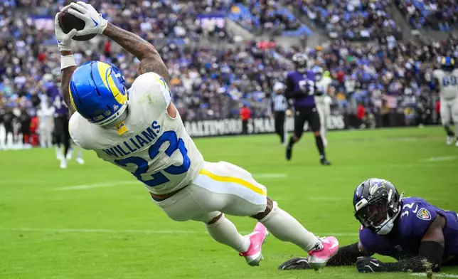 Los Angeles Rams running back Kyren Williams (23) makes a catch after beating the defense of Baltimore Ravens linebacker Trenton Simpson (32) during the second half of an NFL football game Sunday, Oct. 12, 2025, in Baltimore. (AP Photo/Nick Wass)