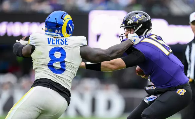 Los Angeles Rams linebacker Jared Verse (8) applies pressure on Baltimore Ravens quarterback Cooper Rush during the second half of an NFL football game Sunday, Oct. 12, 2025, in Baltimore. (AP Photo/Nick Wass)