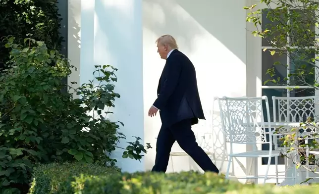 President Donald Trump walks from the Oval Office to board Marine One on the South Lawn of the White House, Friday, Oct. 10, 2025, in Washington, as he heads to Walter Reed National Military Center. (AP Photo/Alex Brandon)