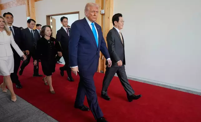 President Donald Trump, center, and South Korean President Lee Jae Myung, right, attend a high honor ceremony at the Gyeongju National Museum in Gyoeongju, South Korea, Wednesday, Oct. 29, 2025. (AP Photo/Mark Schiefelbein)