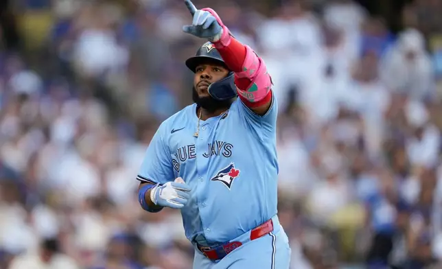Toronto Blue Jays' Vladimir Guerrero Jr. celebrates his solo home run during the first inning in Game 5 of baseball's World Series against the Los Angeles Dodgers, Wednesday, Oct. 29, 2025, in Los Angeles. (AP Photo/Ashley Landis)
