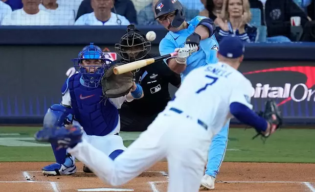Toronto Blue Jays' Davis Schneider connects for a solo home run off Los Angeles Dodgers pitcher Blake Snell (7) leave the park during the first inning in Game 5 of baseball's World Series, Wednesday, Oct. 29, 2025, in Los Angeles. (AP Photo/David J. Phillip)