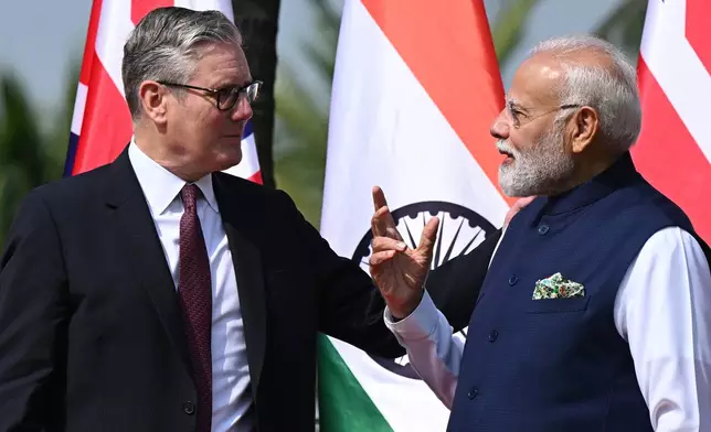 British Prime Minister Keir Starmer, left is greeted by Indian Prime Minister Narendra Modi on his arrival at Raj Bhavan in Mumbai, India, Thursday, Oct. 9, 2025. (Leon Neal/Pool Photo via AP)