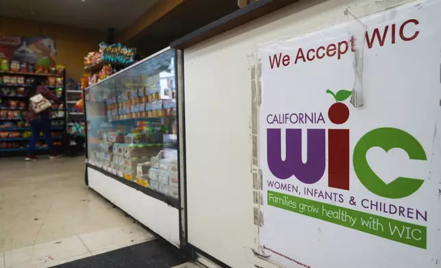 A store post signs accepting WIC payments on Monday, Oct. 27, 2025, in Los Angeles. (AP Photo/Damian Dovarganes)