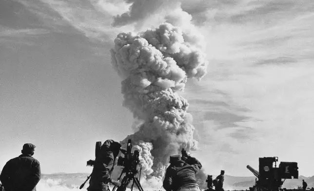 FILE - In this June 1953, file photo, film crews photograph an atom cloud forming after an atomic shell fired a test in the Nevada desert. (AP Photo, File)