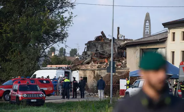 Rescue workers and policemen attend to the scene of an explosion in the town of Castel d’Azzano, 10 km (six miles) southwest Verona, Italy, Tuesday, Oct. 14, 2025. (Claudio Furlan/LaPresse via AP)