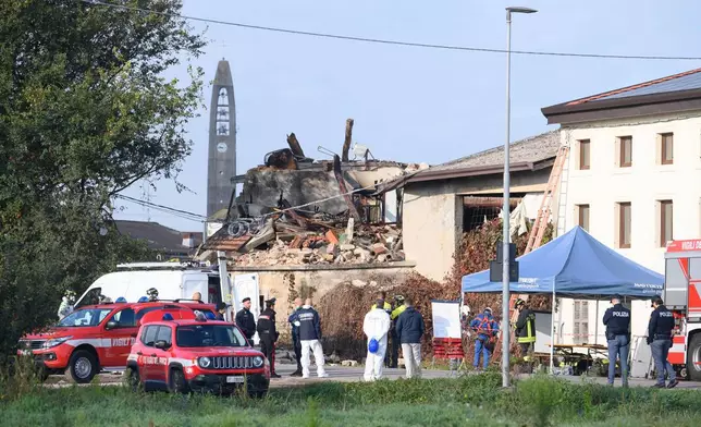 Rescuers inspect a collapsed two-story farmhouse in Castel d'Azzano, some 10 kilometers south-west of Verona, where three carabinieri officers have been killed, and 13 others injured, in an explosion during an eviction, early Tuesday, Oct. 14, 2025. (Claudio Furlan/LaPresse via AP)