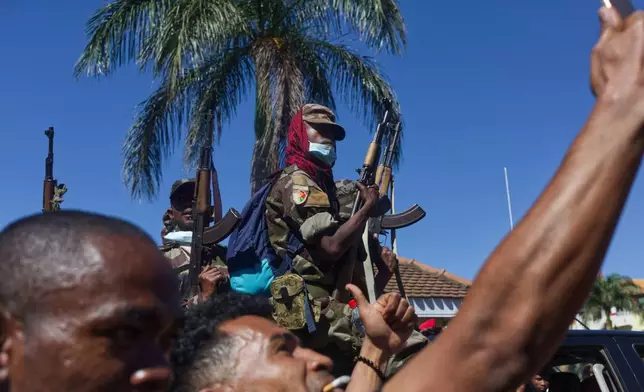 People taking selfies as the soldiers joined anti-government protests in the city center in Antananarivo, Madagascar, Sunday, Oct. 12, 2025. (AP Photo/Alexander Joe)