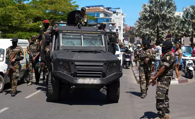 Soldiers are greeted by people gathering for a ceremony in tribute to demonstrators killed during recent anti-government protest in Antananarivo, Madagascar, Sunday, Oct. 12, 2025. (AP Photo/Mamyrael)