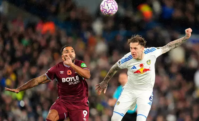 West Ham United's Callum Wilson, left, and Leeds United's Joe Rodon in action during the English Premier League soccer match between Leeds United and West Ham United at Elland Road, Leeds, England, Friday Oct. 24, 2025. (Danny Lawson/PA via AP)