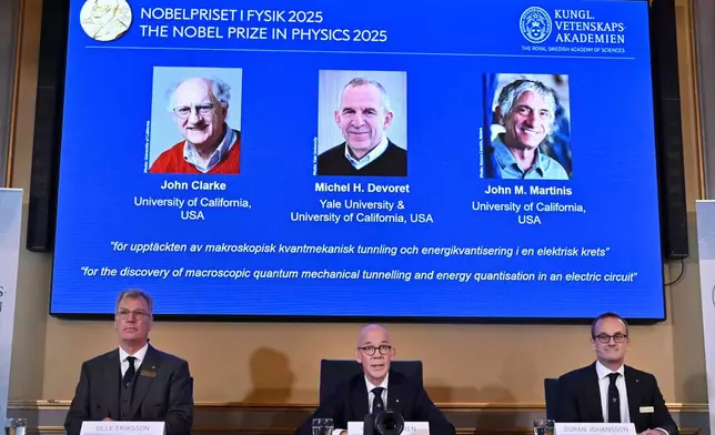 From left, Chair of the Nobel Committee for Physics Chair Olle Eriksson, Secretary General of the Swedish Academy of Sciences Hans Ellegren and Member of the Nobel Committee for Physics Goran Johansson announce John Clarke, Michel H Devoret and John M. Martinis, on screen behind, as the recipients the Nobel Prize in Physics, at the Nobel Assembly of the Karolinska Institutet, in Stockholm, Sweden, Tuesday, Oct. 7, 2025. (Christine Olsson/TT News Agency via AP)