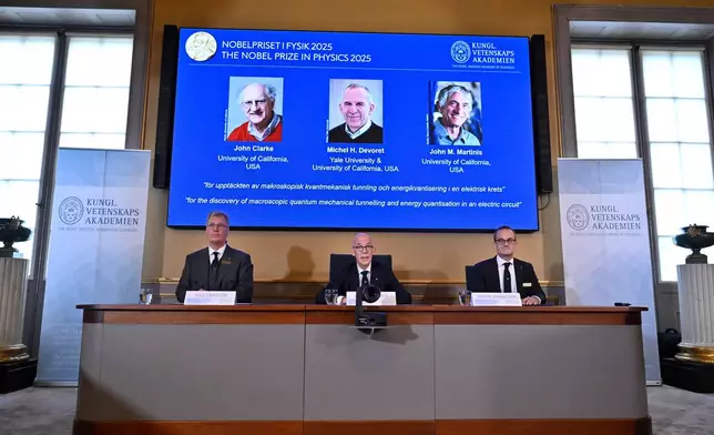 From left, Chair of the Nobel Committee for Physics Chair Olle Eriksson, Secretary General of the Swedish Academy of Sciences Hans Ellegren and Member of the Nobel Committee for Physics Goran Johansson announce John Clarke, Michel H Devoret and John M. Martinis, on screen behind, as the recipients the Nobel Prize in Physics, at the Nobel Assembly of the Karolinska Institutet, in Stockholm, Sweden, Tuesday, Oct. 7, 2025. (Christine Olsson/TT News Agency via AP)