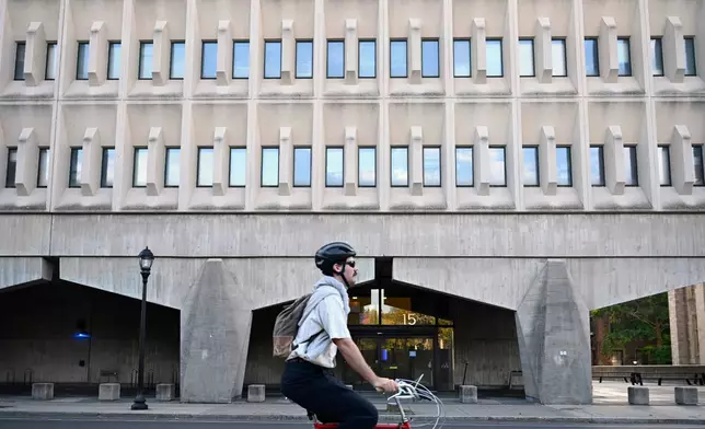 A bicyclist rides past the Becton Engineering and Applied Science Center at Yale University where Yale Professor Emeritus of Applied Physics Michel Devoret has an office and laboratory, Tuesday, Oct. 7, 2025, in New Haven, Conn. (AP Photo/Jessica Hill)