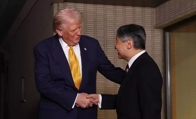President Donald Trump, left, and Japan's Emperor Naruhito shake hands during their meeting at the Imperial Palace in Tokyo, Oct. 27, 2025. (Issei Kato/Pool Photo via AP)