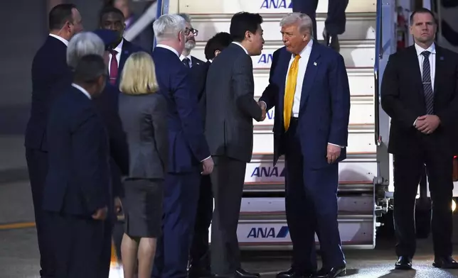 President Donald Trump is welcomed by Japan's newly appointed Chief Cabinet Secretary Minoru Kihara upon arrival at Haneda Tokyo International Airport in Tokyo, Japan, Monday, Oct. 27, 2025, (David Mareuil/Pool Photo via AP)