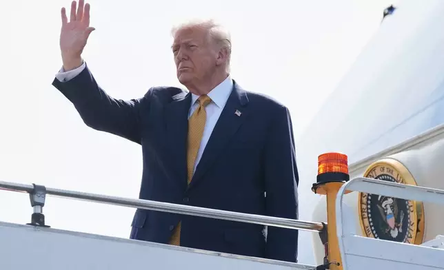 President Donald Trump waves as he boards Air Force One at Kuala Lumpur International Airport in Sepang, Malaysia, as he departs for Japan, Monday, Oct. 27, 2025. (AP Photo/Mark Schiefelbein)