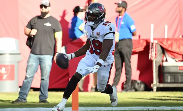 Tampa Bay Buccaneers wide receiver Kameron Johnson (19) celebrates after scoring against the San Francisco 49ers during the first half of an NFL football game in Tampa, Fla., Sunday, Oct. 12, 2025. (AP Photo/Jason Behnken)