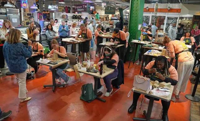 Contestants work on their entries in Scrapple Sculpting Contest at the Reading Terminal Market in Philadelphia, Friday, Oct. 10, 2025. (AP Photo/Matt Rourke)
