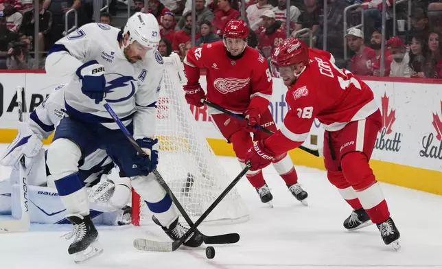 Tampa Bay Lightning defenseman Ryan McDonagh (27) blocks a Detroit Red Wings center Andrew Copp (18) shot in the second period of an NHL hockey game Friday, Oct. 17, 2025, in Detroit. (AP Photo/Paul Sancya)