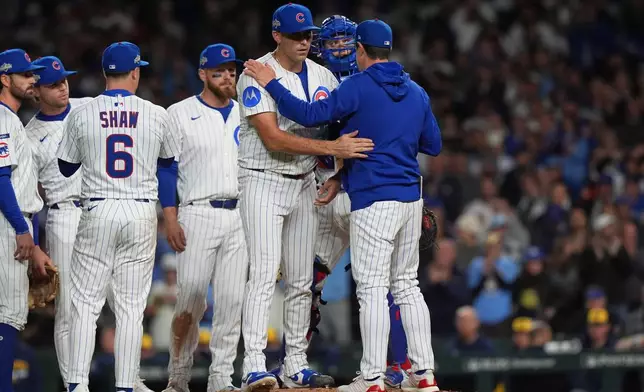 Chicago Cubs manager Craig Counsell acknowledges starting pitcher Matthew Boyd (16) while making a pitching change during the fifth inning of Game 4 of baseball's National League Division Series against the Milwaukee Brewers Thursday, Oct. 9, 2025, in Chicago. (AP Photo/Nam Y. Huh)