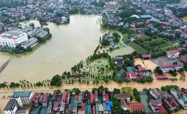 This aerial image shows flooding caused by rain following typhoon Bualoi in Lao Cai, Vietnam, Tuesday, Sept. 30, 2025. (Do Tuan Anh/VNA via AP)