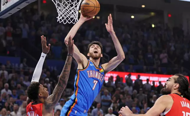 Oklahoma City Thunder center Chet Holmgren (7) looks to shoot over Houston Rockets forward Jabari Smith Jr., left, during the first half of an NBA basketball game Tuesday, Oct. 21, 2025, in Oklahoma City. (AP Photo/Nate Billings)
