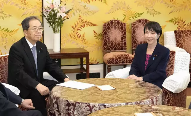 Sanae Takaichi, right, the newly-elected leader of Japan's ruling party, the Liberal Democratic Party (LDP), and Tetsuo Saito, leader of Komeito, pose for photo before their talk at the parliament in Tokyo, Friday, Oct. 10, 2025. (Daisuke Suzuki/Kyodo News via AP)