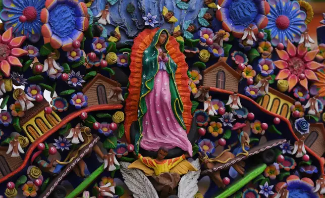 A statue of the Virgin of Guadalupe decorates a tree of life sculpture in the main square of Metepec, Mexico, Thursday, Oct. 9, 2025. (AP Photo/Fernando Llano)