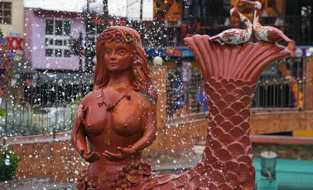 A fountain with a figure of Tlanchana, a half-woman half-serpent figure who legend has it once ruled the waters around the town, decorates the main square of Metepec, Mexico, Thursday, Oct. 9, 2025. (AP Photo/Fernando Llano)