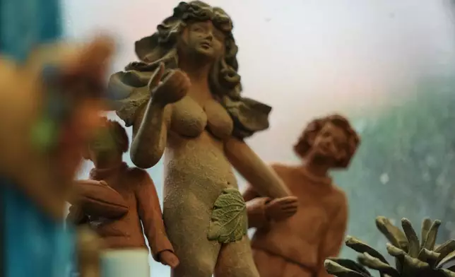 An image of Eve is displayed at the atelier of the Mexican craftsman Cecilio Sanchez in Metepec, Mexico, Thursday, Oct. 9, 2025. (AP Photo/Fernando Llano)