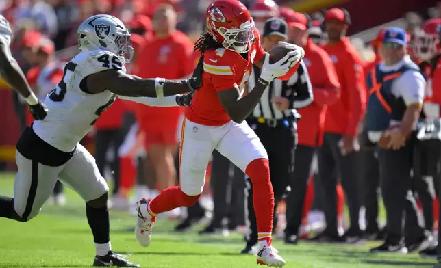 Kansas City Chiefs wide receiver Rashee Rice (4) is pushed out of bounds by Las Vegas Raiders linebacker Devin White (45) during the first half of an NFL football game Sunday, Oct. 19, 2025, in Kansas City, Mo. (AP Photo/Reed Hoffmann)