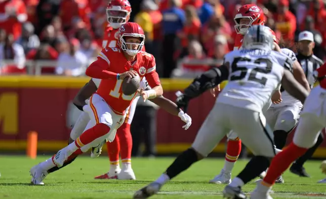 Kansas City Chiefs quarterback Patrick Mahomes scrambles during the first half of an NFL football game against the Las Vegas Raiders Sunday, Oct. 19, 2025, in Kansas City, Mo. (AP Photo/Reed Hoffmann)
