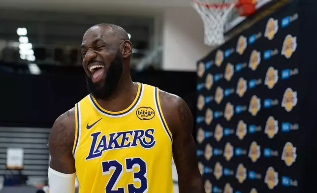 Los Angeles Lakers' LeBron James shares a laugh with a reporter during the NBA basketball team's media day in El Segundo, Calif., Monday, Sept. 29, 2025. (AP Photo/Jae C. Hong)