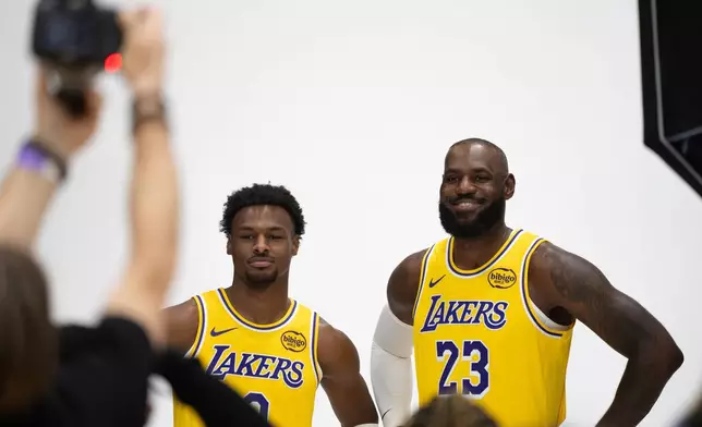 Los Angeles Lakers' LeBron James (23) and Bronny James (9) pose for photos during the NBA basketball team's media day in El Segundo, Calif., Monday, Sept. 29, 2025. (AP Photo/Jae C. Hong)