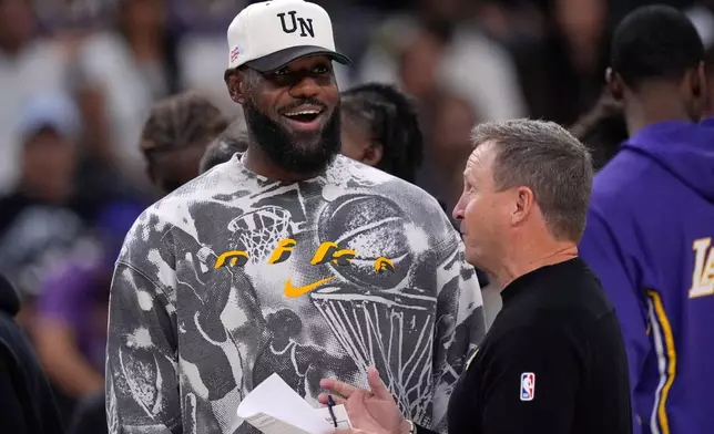 Los Angeles Lakers forward LeBron James, left, talks with assistant coach Scott Brooks during the second half of an NBA preseason basketball game against the Phoenix Suns, Friday, Oct. 3, 2025, in Palm Desert, Calif. (AP Photo/Mark J. Terrill)