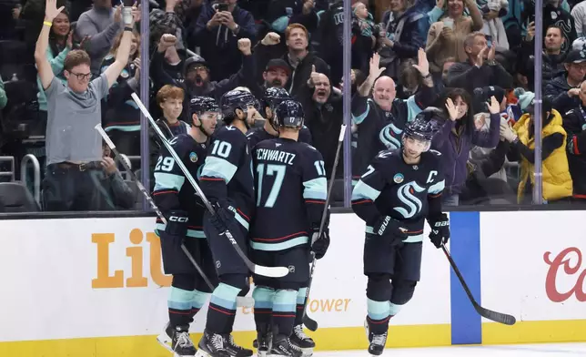 Seattle Kraken right wing Jordan Eberle (7) celebrates his goal with teammates against the Edmonton Oilers in the third period of an NHL hockey game Saturday, Oct. 25, 2025, in Seattle. (AP Photo/John Froschauer)