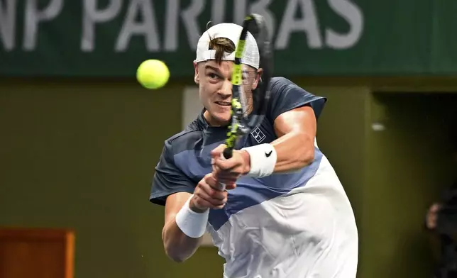 Denmark's Holger Rune plays a return to France's Ugo Humbert in the men's singles semifinal tennis match of the BNP Paribas Nordic Open tennis tournament in Stockholm, Sweden, Saturday, Oct. 18, 2025. (Anders Wiklund/TT via AP)