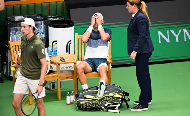 Denmark's Holger Rune reacts after injuring his foot during the men's singles semifinal tennis match against France's Ugo Humbert at the BNP Paribas Nordic Open tennis tournament in Stockholm, Sweden, Saturday, Oct. 18, 2025. (Anders Wiklund/TT via AP)