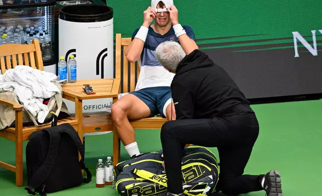 Denmark's Holger Rune injures his foot during the men's singles semifinal tennis match against France's Ugo Humbert at the BNP Paribas Nordic Open tennis tournament in Stockholm, Sweden, Saturday, Oct. 18, 2025. (Anders Wiklund/TT via AP)