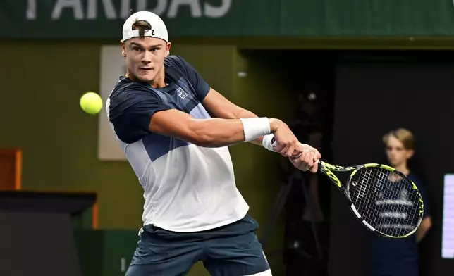 Denmark's Holger Rune plays a return to France's Ugo Humbert in the men's singles semifinal tennis match of the BNP Paribas Nordic Open tennis tournament in Stockholm, Sweden, Saturday, Oct. 18, 2025. (Anders Wiklund/TT via AP)