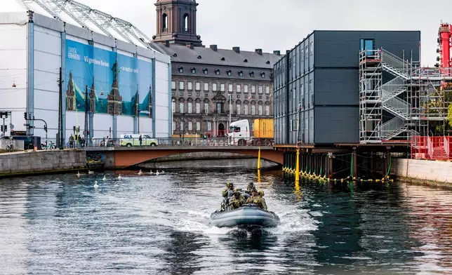 Security on a dinghy boat around the Danish parliament at Christiansborg Castle in Copenhagen as Denmark is hosting an informal summit for the EUs heads of state and government, Wednesday, Oct. 1, 2025 . (Steven Knap/Ritzau Scanpix via AP)